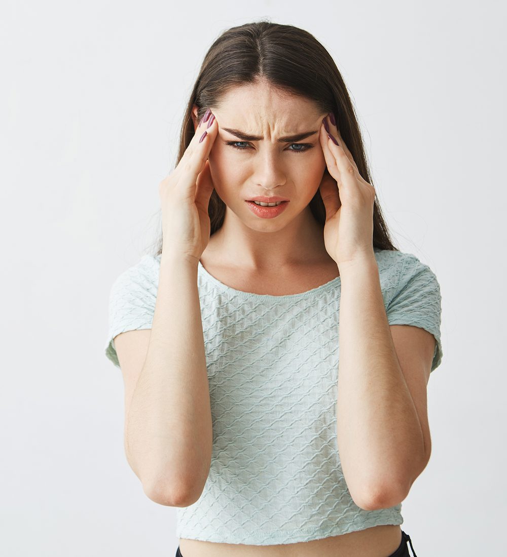 woman suffers headache before migraine surgery