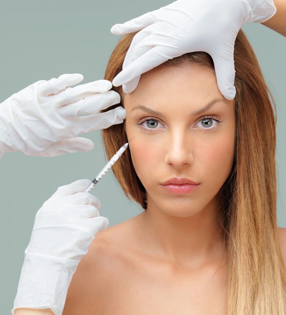 young-woman-with-doctor-hands-injecting-botox